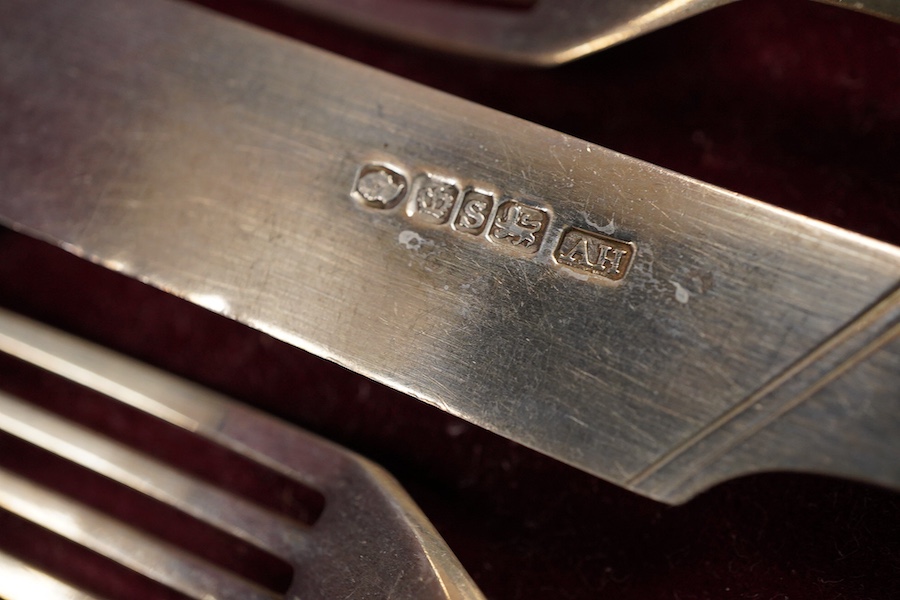 A set of twelve pairs of early Victorian mother of pearl handled dessert eaters, by Aaron Hadfield & Sons, Sheffield, 1838, no date letter on the forks, knife 19.1cm, housed in a mahogany canteen.